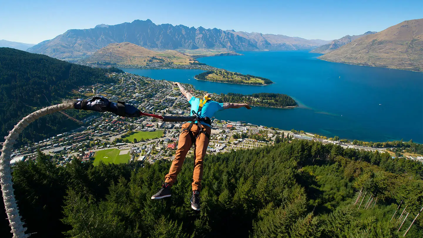 A bungy jumper falling from the Ledge platform above Queenstown