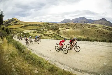 Mountain bikers racing through the Motatapu high country