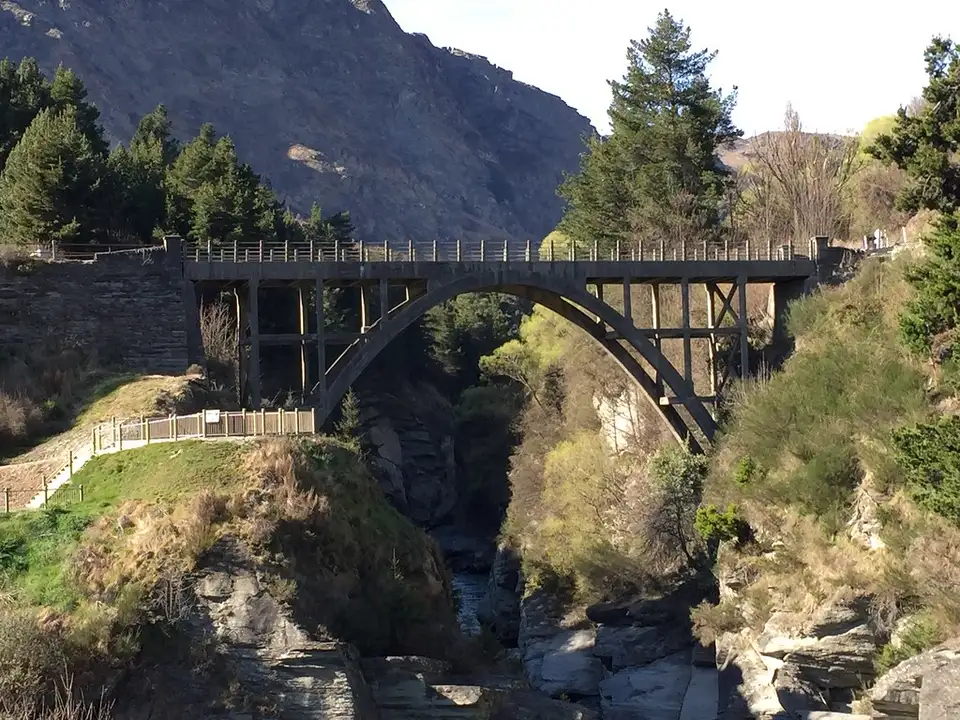 An arched concrete bridge crossing the Shotover gorge at Arthurs Point