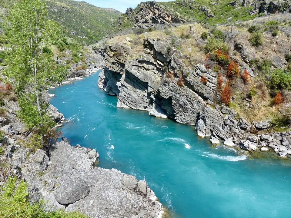 The Kawarau River running turquoise between steep schist bluffs