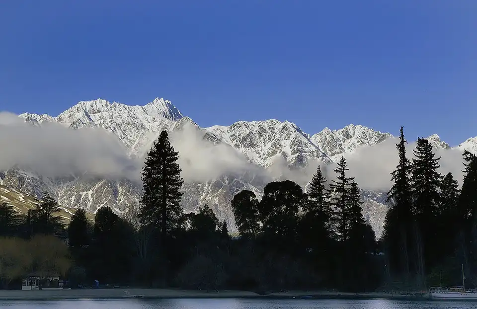 Fresh snow along the ridgeline of The Remarkables above golden tussock slopes