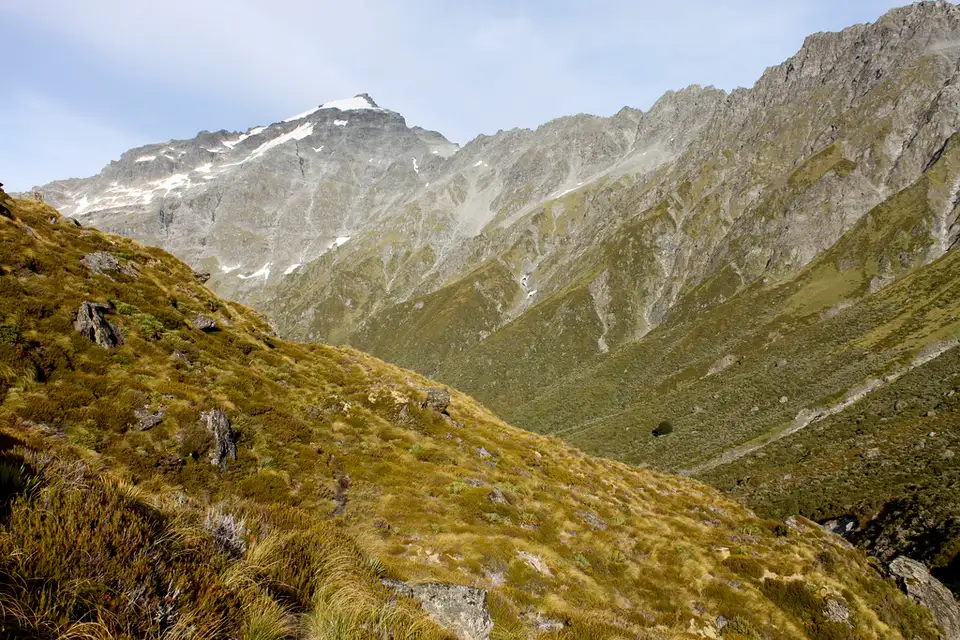 Tussock slopes and a rocky peak in the upper Rees valley, on the climb towards Rees Saddle