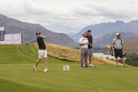 Brendon McCullum L drives off the first tee at The Hills watched by Ryan Fox C and Stephen Fleming